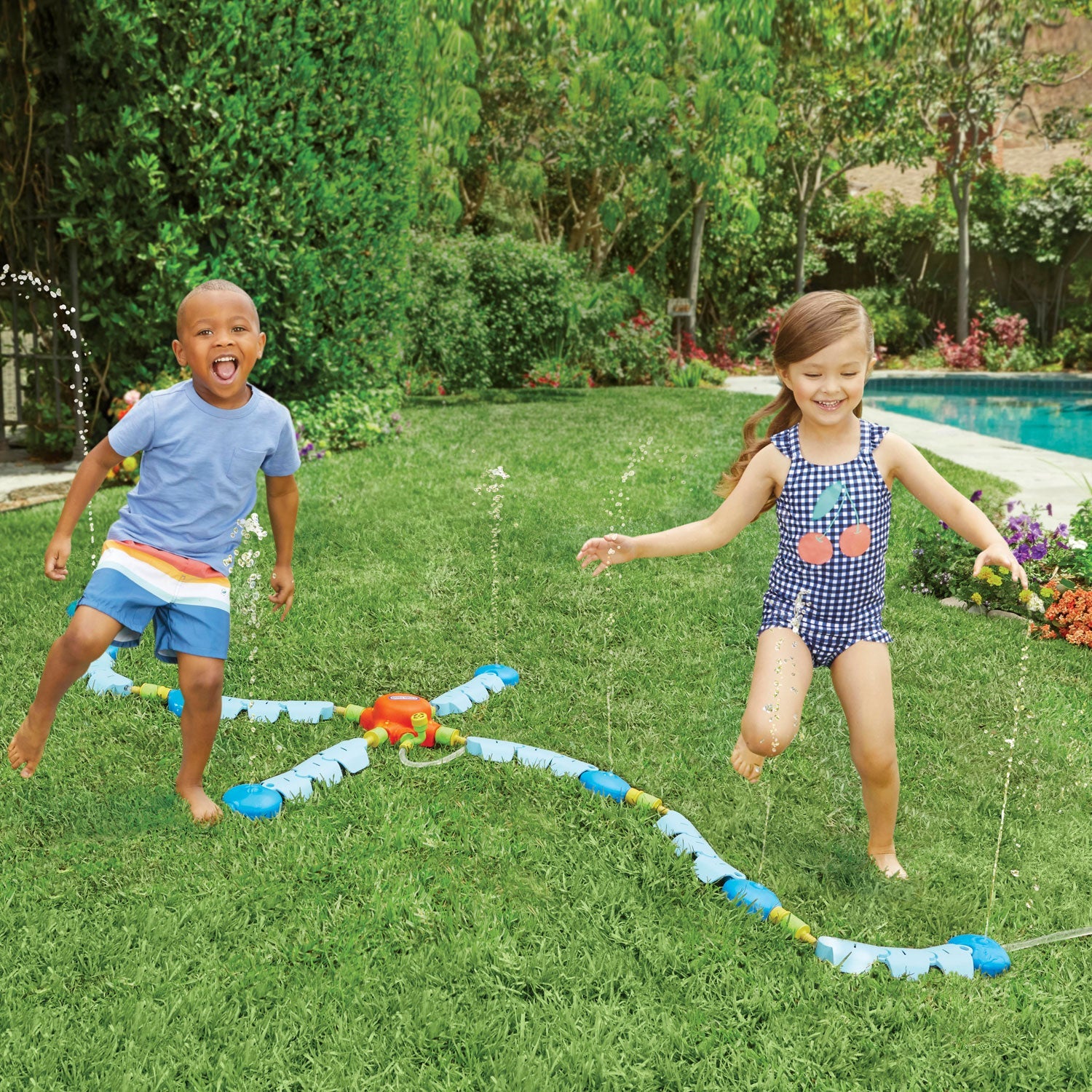 Kids playing with the sprinkler